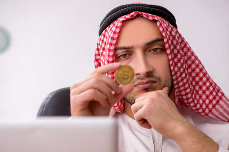Young male arab employee working in the officeの写真素材