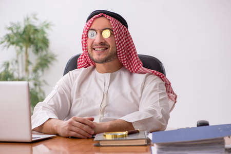Young male arab employee working in the officeの写真素材