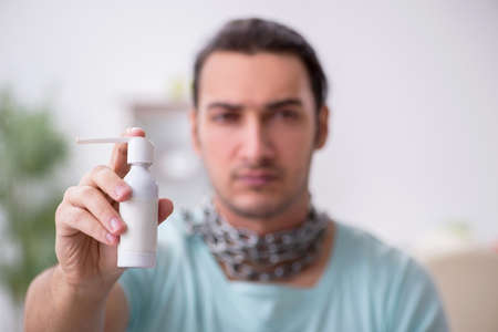 Young man suffering from sore throatの写真素材