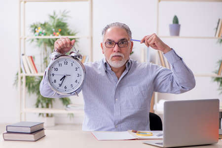 Old male teacher in the classroom