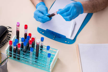 Old male doctor working in the clinic