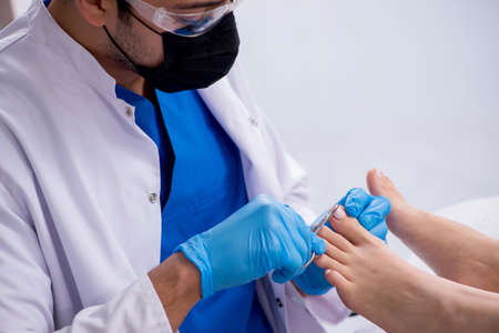 Podiatrist treating feet during procedureの写真素材