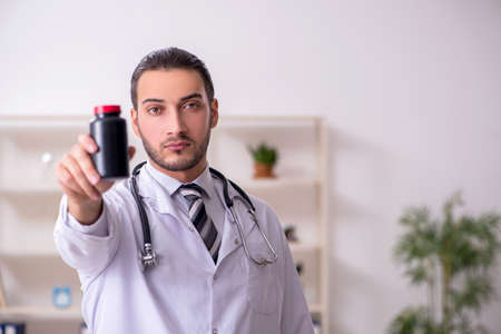 Young male doctor working in the clinicの写真素材