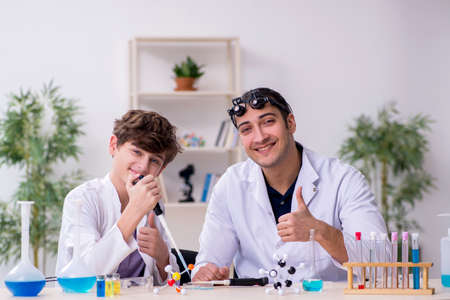 Young father and son chemists in the labの写真素材