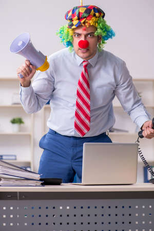 Funny employee clown working in the officeの写真素材