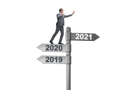 Road sign and businessman with 2020 and 2021