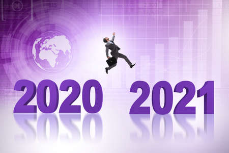 Businessman jumping from the year 2020 to 2021
