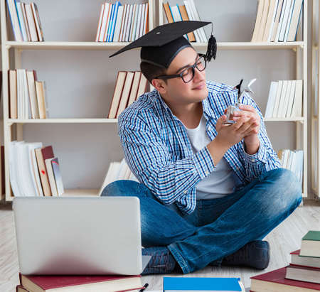 Young student studying with booksの写真素材