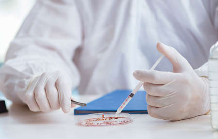 Chemist working in the laboratory with hazardous chemicals