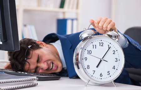 Businessman employee in urgency and deadline concept with alarmの写真素材