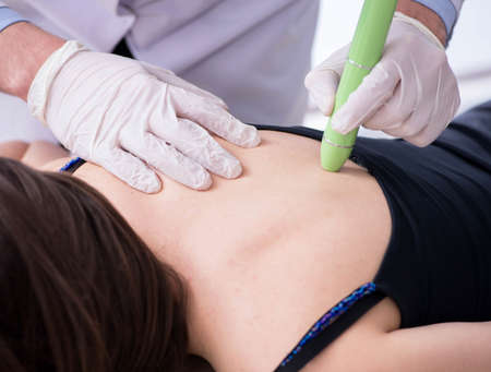 Patient in clinic undergoing laser scar removal
