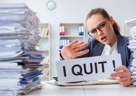 The businesswoman not coping with workload and resigningの写真素材