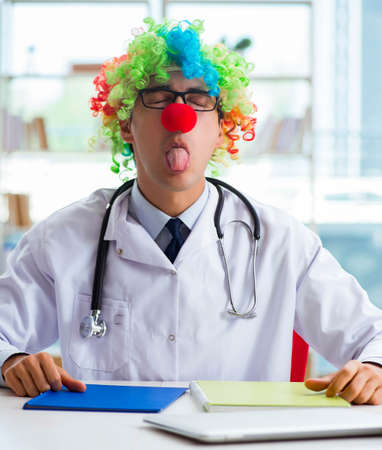 Funny pediatrician with clown wig in the hospital clinicの写真素材