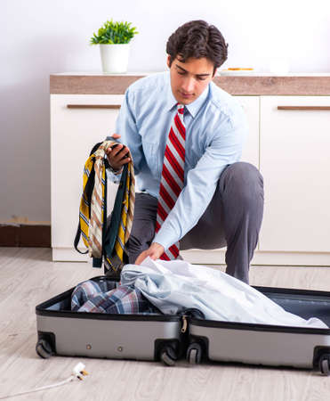 Young handsome businessman preparing for tripの写真素材