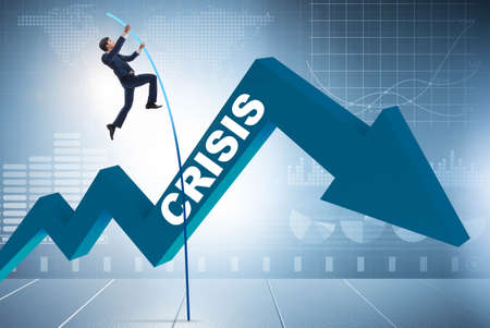 Businessman pole vaulting over crisis in business concept