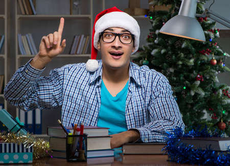 Young man working at home on christmas dayの写真素材