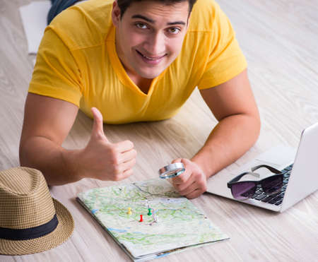 Man planning his vacation trip with mapの写真素材