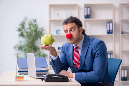 Funny employee clown working in the officeの写真素材