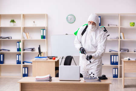 Contractor disinfecting office for COVID-19 coronavirusの写真素材
