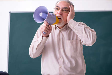 Old male teacher in the classroomの写真素材
