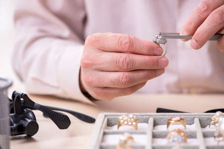 Old male jeweler at workshop
