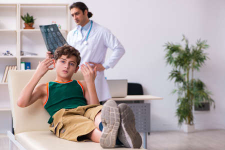 Sick boy visiting young male doctor pediatricianの写真素材