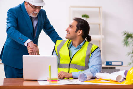 Two male architects working in the officeの写真素材