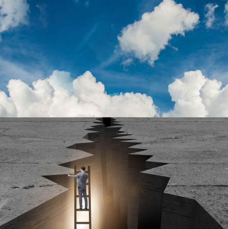 Businessman escapeing from gap on ladderの写真素材