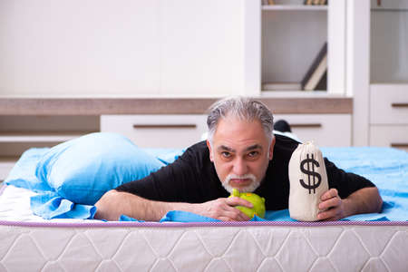 Unhappy old man in retirement conceptの写真素材