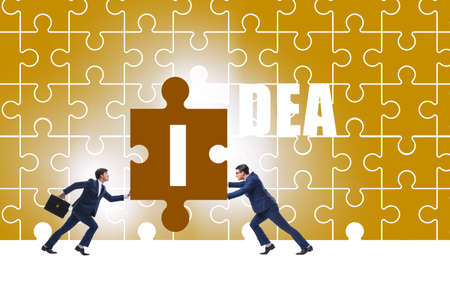 Idea concept with businessman putting jigsaw puzzleの写真素材