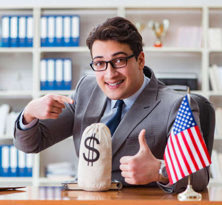 Businessman with American flag in officeの写真素材