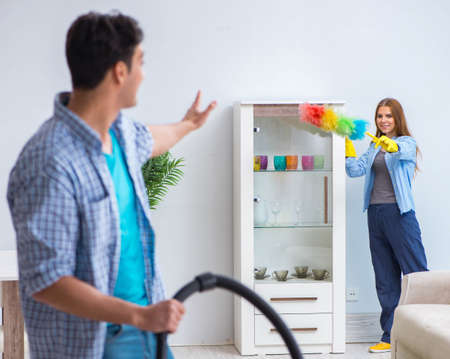 Young family cleaning the house