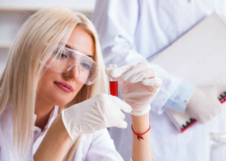 Young female woman doctor in hospital clinic labの写真素材