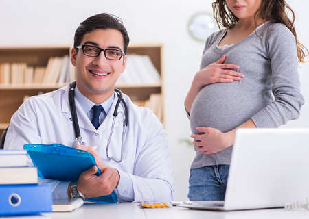 Pregnant woman visiting doctor for consultationの写真素材