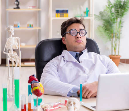 Funny doctor having fun in hospital labの写真素材