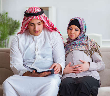 Young arab muslim family with pregnant wife expecting babyの写真素材