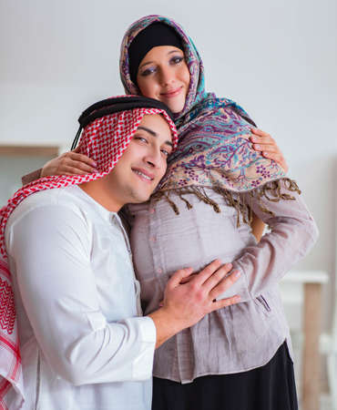 Young arab muslim family with pregnant wife expecting babyの写真素材