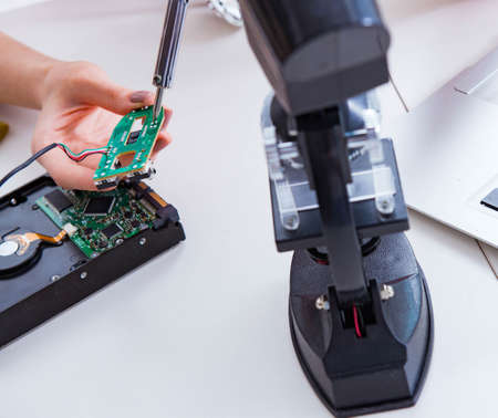 Engineer fixing broken computer hard drive