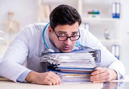 Busy doctor with too much work in hospitalの写真素材