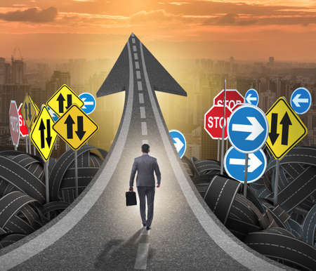 Businessman in uncertainty concept on road intersection crossroaの写真素材