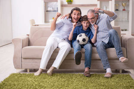 Boy and his father and his grandfother indoor