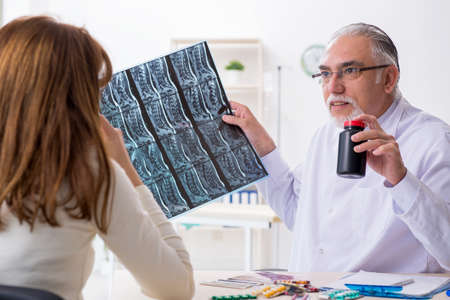 Young woman visiting experienced doctor radiologist