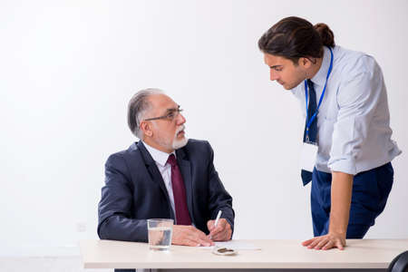 Old businessman meeting with advocate in pre-trial detentionの写真素材