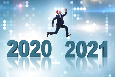 Businessman jumping from the year 2020 to 2021