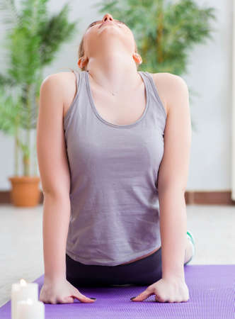 Young woman exercising in sports hall in healthy conceptの写真素材