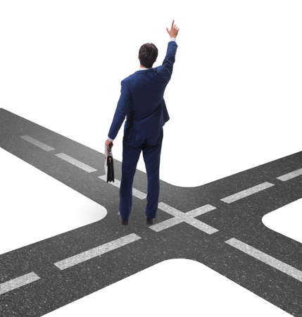Young businessman at crossroads in uncertainty conceptの写真素材