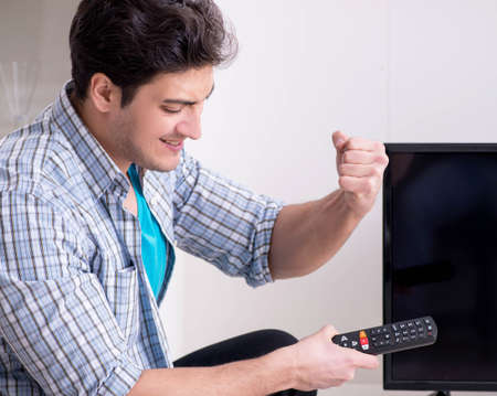 Man trying to fix broken tv