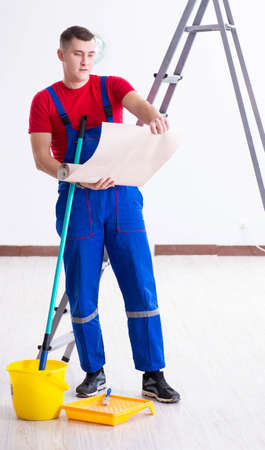 Contractor worker preparing for wallpaper decorationの写真素材