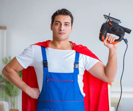Super hero repairman working at homeの写真素材