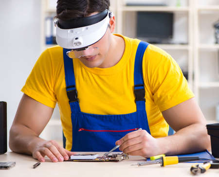Computer repair technician repairing hardwareの写真素材